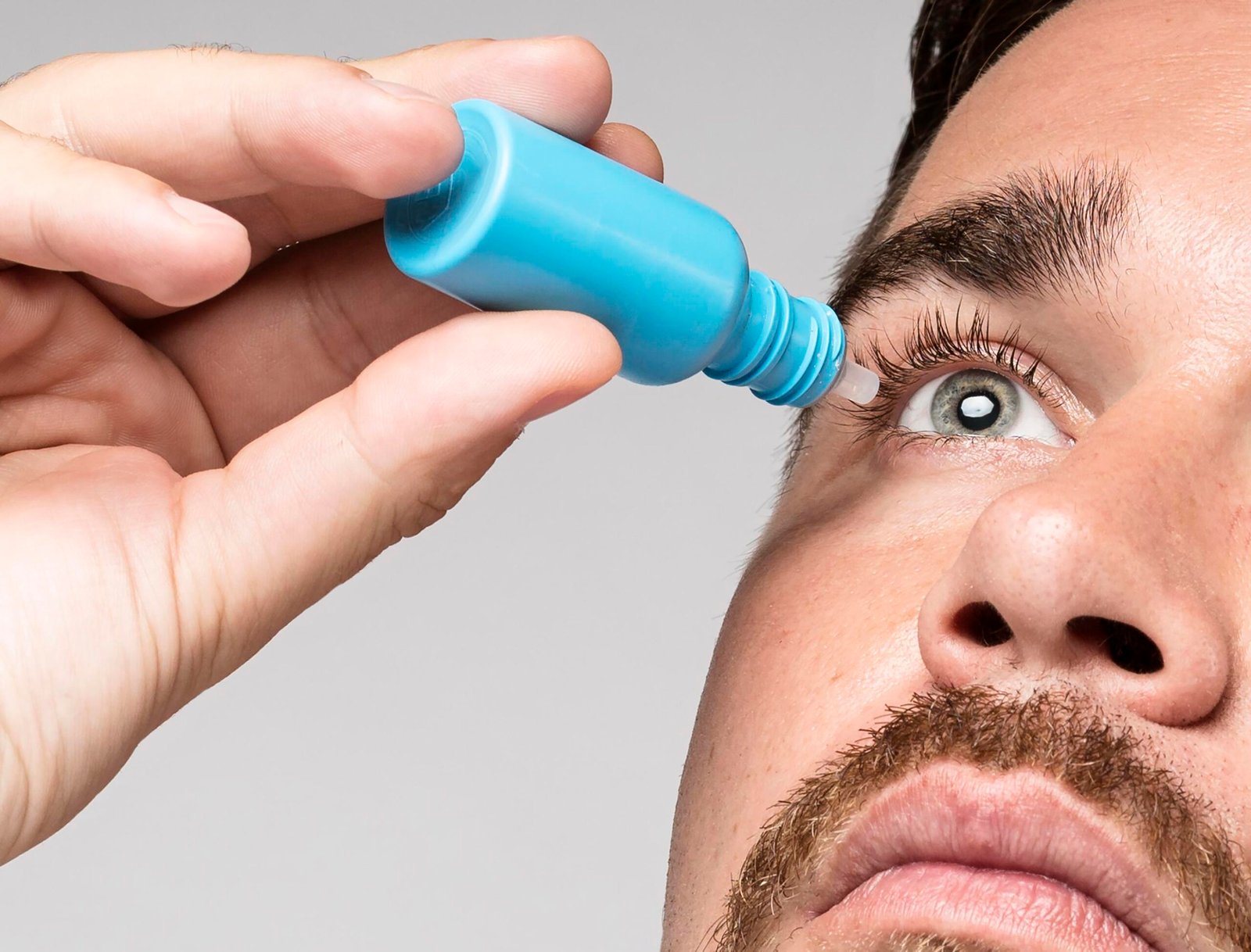 man-using-eye-drops-close-up